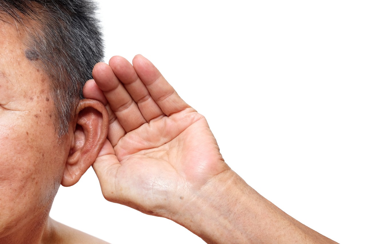 man-listening man cupping ear to help hearing