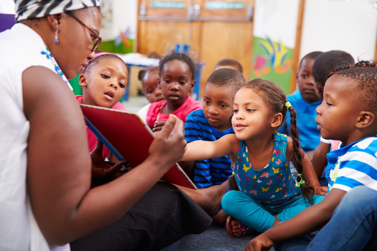 teacher-reading-with-students teacher reading to students in classroom