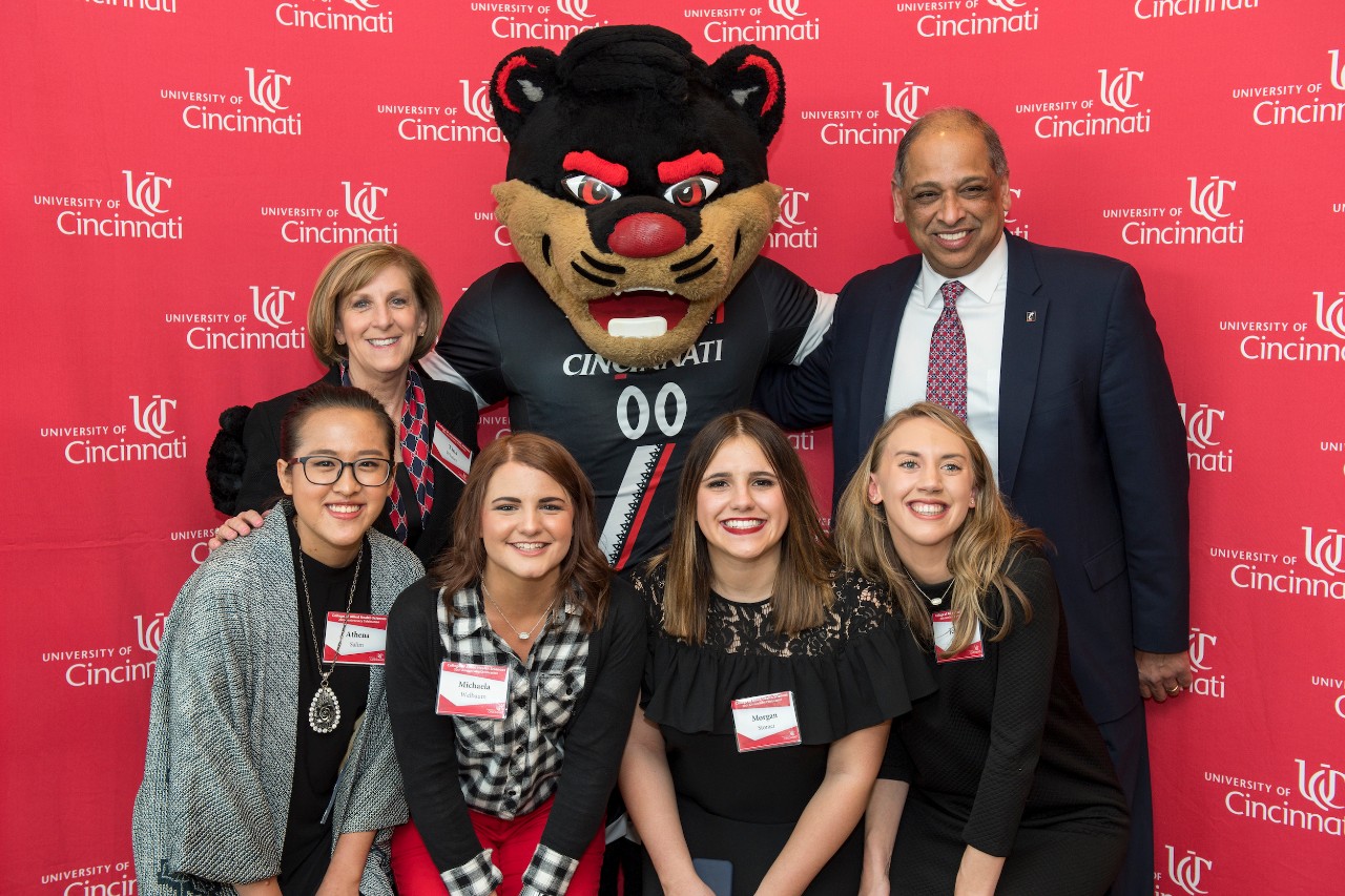 Alumni with dean, president and Bearcat at anniversary celebration
