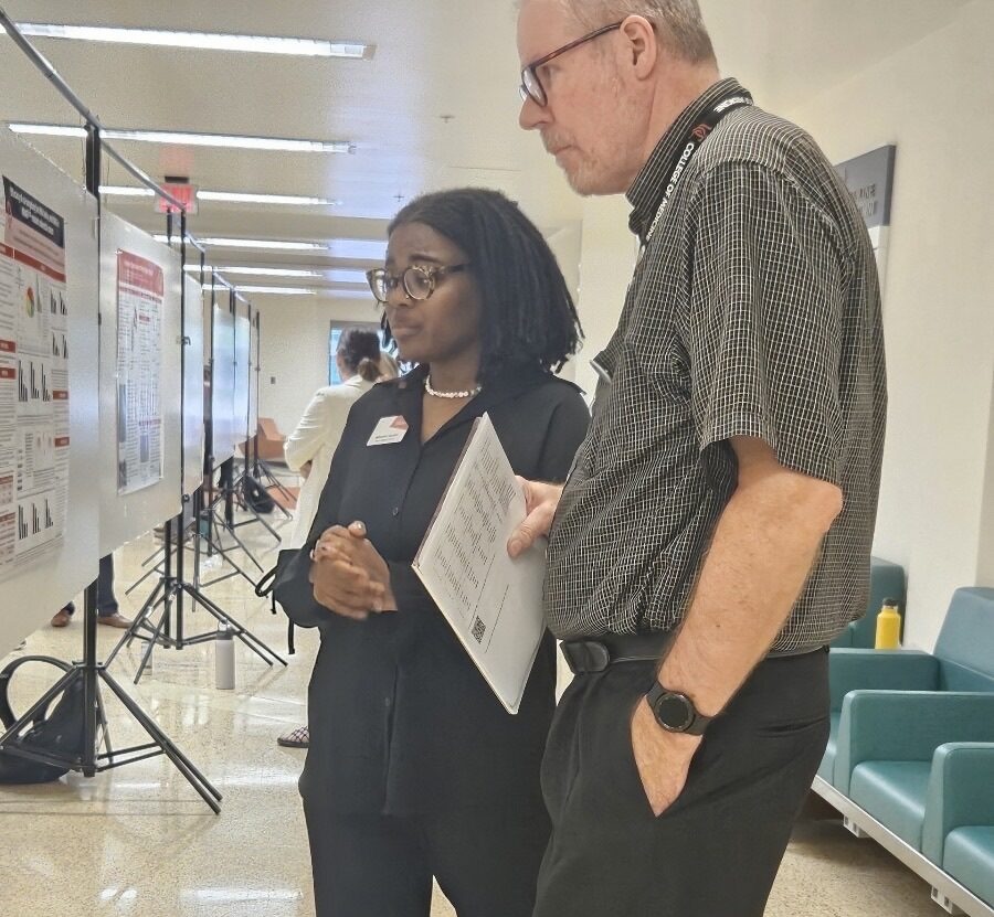 Student with faculty member at a research poster 