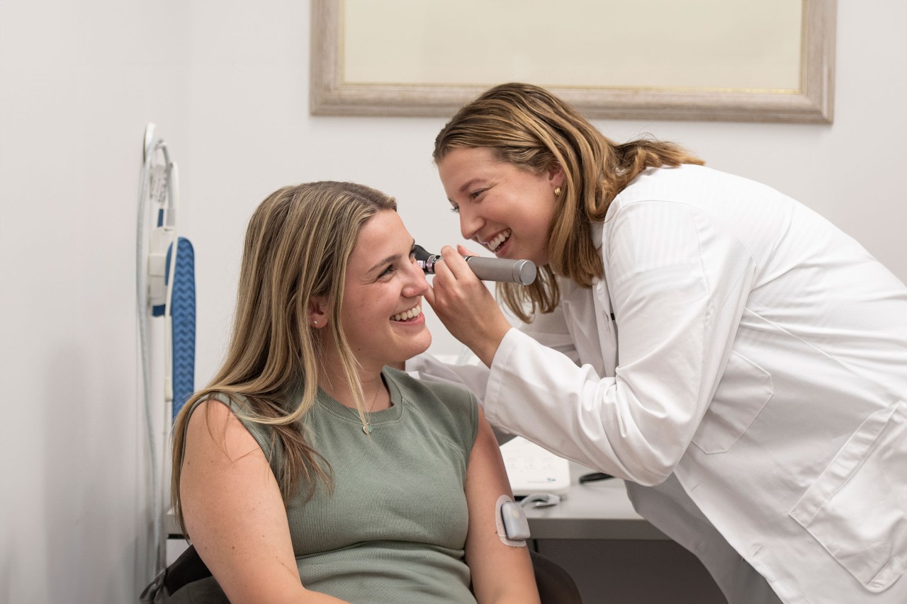 A University of Cincinnati College of Allied Health student evaluates a patient